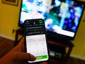 DraftKings app in hand infront of TV